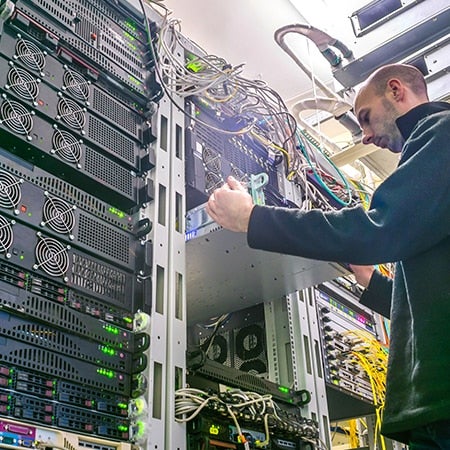 technician performs diagnostics on computer hardware